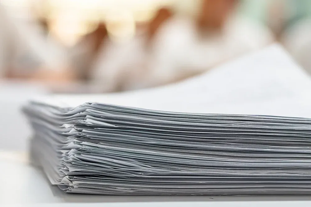 A stack of papers representing Requested Test Scores.